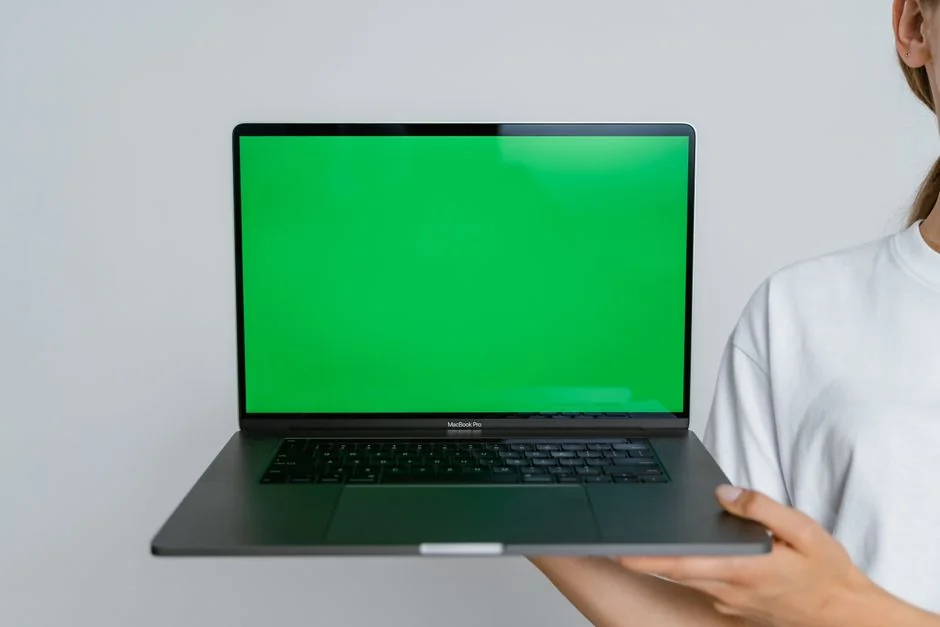 A neatly arranged design workstation featuring dual monitors with design software displayed on screen.